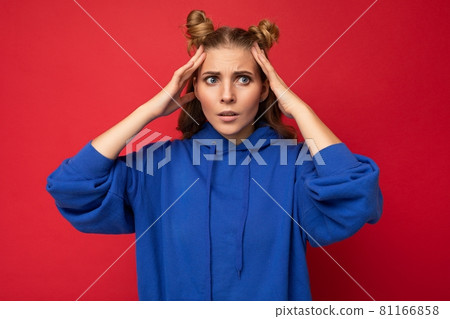Photo of emotional shocked young pretty blonde woman with two horns with sincere emotions wearing 81166858