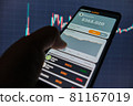 Smartphone with mobile application cryptocurrency wallet. A man analyzes the price chart for ethereum in a mobile application. The concept of cryptocurrency trading  81167019