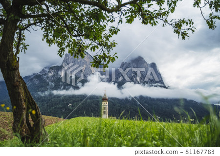St Valentine's Church, Seis am Schlern, Italy. Schlern mountain with rainy clouds in background 81167783