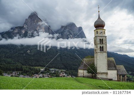 St Valentine's Church, Seis am Schlern, Italy. Schlern mountain with rainy clouds in background St Valentine's Church, Seis am Schlern, Italy. Schlern mountain with rainy clouds in background 81167784