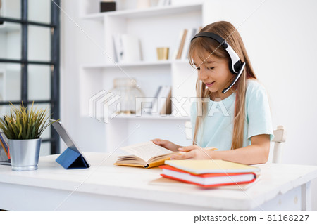 Little caucasian girl in headphones have video call distant class with teacher at home Little caucasian girl in headphones have video call distant class with teacher at home 81168227