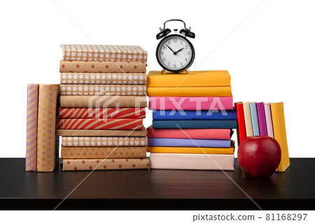 Stack of books and apple on tabletop against white background 81168297