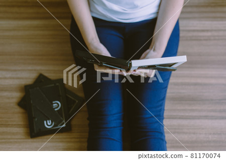 Woman looking photo album at home,Memory time photos,Top view 81170074