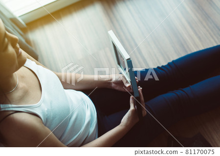 Beautiful happy asian woman looking photo album at home,Memory time photos,Happy and smiling 81170075