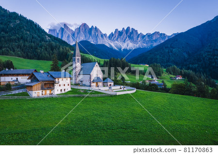 St Magdalena church in Val di Funes valley, Dolomites, Italy. Furchetta and Sass Rigais mountain peaks in background St Magdalena church in Val di Funes valley, Dolomites, Italy. Furchetta and Sass Rigais mountain peaks in background 81170863