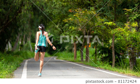 Healthy woman warming up before jogging run and relax stretching her arms and looking away in the road outdoor. Healthy woman warming up before jogging run and relax stretching her arms and looking away in the road outdoor. 81172424