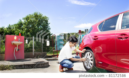 A man washing a red car on a sunny day in midsummer A man washing a red car on a sunny day in midsummer 81172586