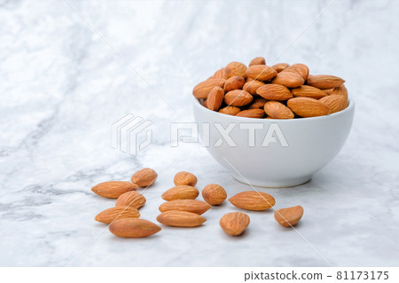 Almonds nuts on marble background.. Almonds nuts on marble background.. 81173175