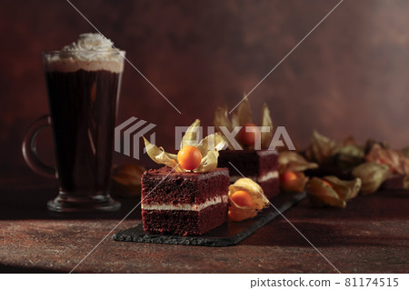 Chocolate cake with physalis on a brown background. 81174515
