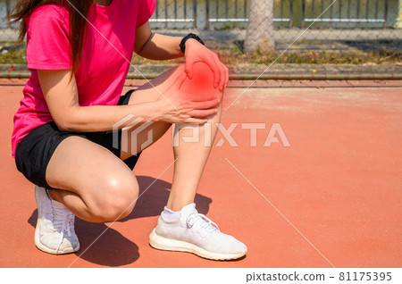 Cropped shot of woman runner suffering from knee pain. It often happens when your kneecap is out of alignment. Conceptual of common running injuries. Cropped shot of woman runner suffering from knee pain. It often happens when your kneecap is out of alignment. Conceptual of common running injuries. 81175395