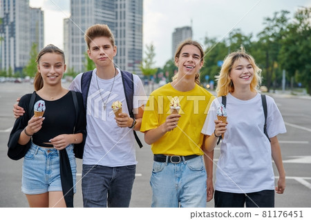 Group portrait of happy teenagers walking together with ice cream Group portrait of happy teenagers walking together with ice cream 81176451