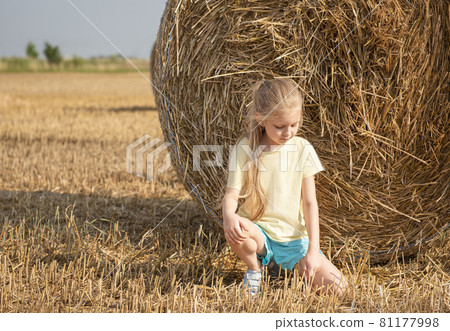 Little girl having fun in a wheat field on a summer day. Little girl having fun in a wheat field on a summer day. 81177998