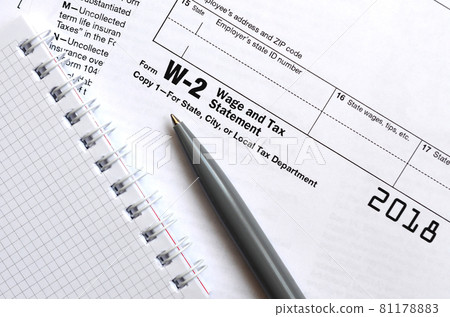 The pen and notebook on the tax form W-2 Wage and Tax Statement. The time to pay taxes The pen and notebook on the tax form W-2 Wage and Tax Statement. The time to pay taxes 81178883