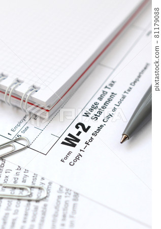 The pen and notebook on the tax form W-2 Wage and Tax Statement. The time to pay taxes 81179088