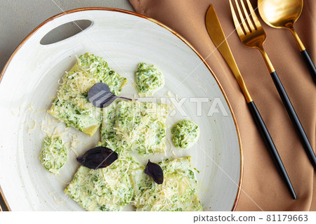 Russian dumpling served with parsley and cheese on plate Russian dumpling served with parsley and cheese on plate 81179663