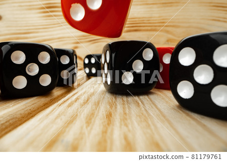 Red and black dice cubes on wooden background Red and black dice cubes on wooden background 81179761