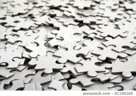 Close-up of a pile of uncompleted elements of a white puzzle. A huge number of rectangular pieces from one large white mosaic Close-up of a pile of uncompleted elements of a white puzzle. A huge number of rectangular pieces from one large white mosaic 81180160