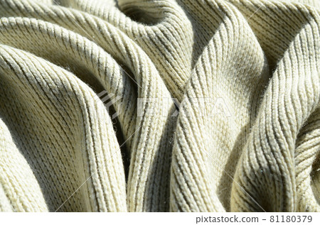 Fabric texture of a soft yellow knitted sweater. Macro image of the structure of bindings in yarns Fabric texture of a soft yellow knitted sweater. Macro image of the structure of bindings in yarns 81180379