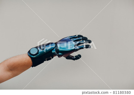 Disabled man with artificial prosthetic hand close up hand against gray background. Disabled man with artificial prosthetic hand close up hand against gray background. 81180380