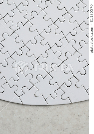A white jigsaw puzzle in the complete form lies on a treated stone surface. Textured image with copy space A white jigsaw puzzle in the complete form lies on a treated stone surface. Textured image with copy space 81180570