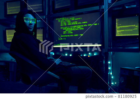 Cyber hacker breaks into databases to obtain information using a computer. Cyber hacker breaks into databases to obtain information using a computer. 81180925