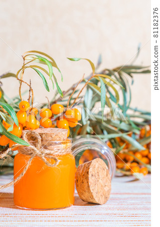 Hippophae sea buckthorn oil cosmetic in a glass bottle on a background with a copy space, alternative herbal medicine and cosmetology Hippophae sea buckthorn oil cosmetic in a glass bottle on a background with a copy space, alternative herbal medicine and cosmetology 81182376