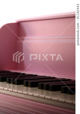 Close-up of the keyboard of a pink piano. Set of white and black buttons 81182443