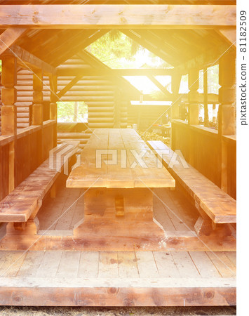 Interior of a wooden arbor handmade from dark wood in the woodland 81182509