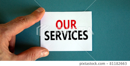 Words 'our services' on the white card between fingers. Beautiful blue background, business concept. Copy space. 81182663