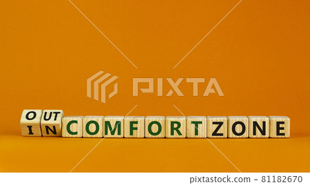 Out or in comfort zone symbol. Turned wooden cubes and changed words 'in comfort zone' to 'out comfort zone'. Beautiful orange background, copy space. Business, psychology concept. Out or in comfort zone symbol. Turned wooden cubes and changed words 'in comfort zone' to 'out comfort zone'. Beautiful orange background, copy space. Business, psychology concept. 81182670
