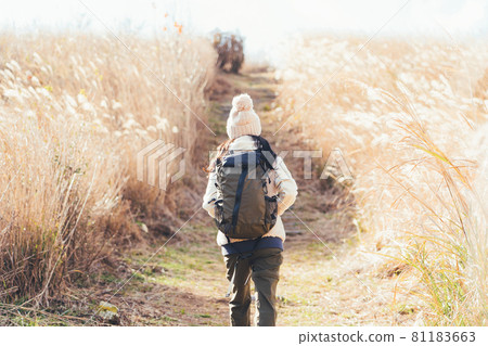 A woman trekking on the raw stone plateau 81183663