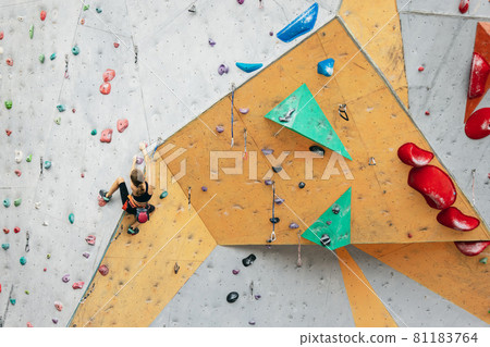 One cute teen girl with climbing equipment practicing on rock wall outdoors. Little hiker. Active lifestyle concept One cute teen girl with climbing equipment practicing on rock wall outdoors. Little hiker. Active lifestyle concept 81183764
