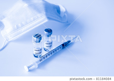 Covid-19 Prevention concept : vial of Covid-19 vaccine, 1 ml plastic syringe with needle and mask Covid-19 Prevention concept : vial of Covid-19 vaccine, 1 ml plastic syringe with needle and mask 81184084