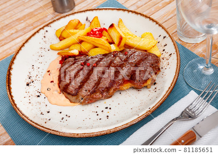 Image of a grilled beef steak and fried potatoes. Image of a grilled beef steak and fried potatoes. 81185651