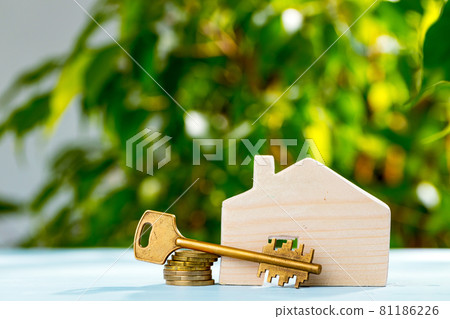 Wooden toy house and house keys close up 81186226