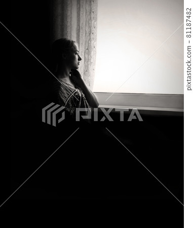 Disabled person in stroller by window Disabled person in stroller by window 81187482