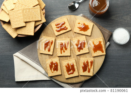 Tasty snack concept with cookies with caramel on dark wooden table Tasty snack concept with cookies with caramel on dark wooden table 81190061
