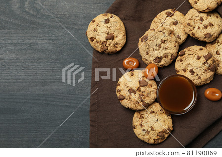 Napkin with cookies and caramel on dark wooden background Napkin with cookies and caramel on dark wooden background 81190069