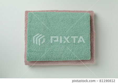 Clean folded towels on light gray background, top view Clean folded towels on light gray background, top view 81190812
