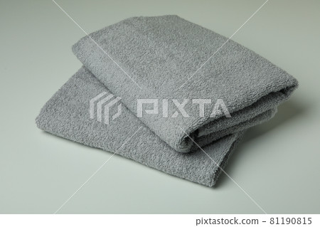 Clean folded towels on light gray background, close up 81190815