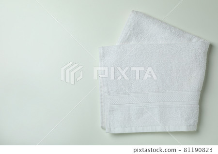 Clean folded towels on white background, space for text 81190823