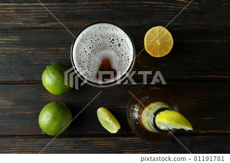 Beer with lime on wooden background, top view Beer with lime on wooden background, top view 81191781