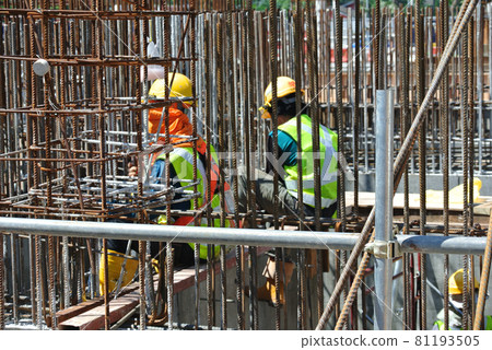 SELANGOR, MALAYSIA -JUNE 15, 2016: Hot rolled deformed steel bars or steel reinforcement bar at construction site. It use to strengthen concrete. Cover by timber form work. 81193505