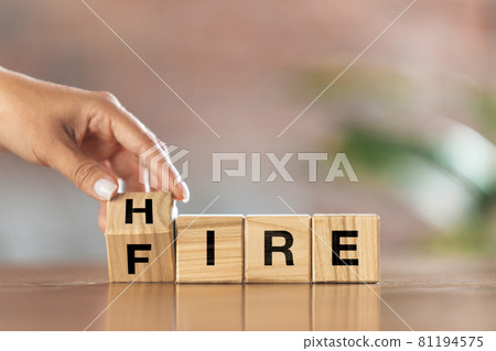 Children's cubes, blocks with word FIRE in female hand. Conceptual image about human rights, education, social issues, mental health, education and personal development. 81194575