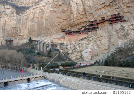 The Hanging Temple or Hanging Monastery near Datong in Shanxi Province, China. Frozen river in the foreground.The Chinese characters mean "spectacular". Some ancient Chinese script is also visible. 81195132