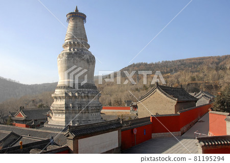 Wutaishan, Shanxi Province in China. Great White Pagoda or Dabaita or Sarira Stupa at Tayuan Temple, with view of mountains behind. Wutaishan is one of the four sacred mountains in Chinese Buddhism. Wutaishan, Shanxi Province in China. Great White Pagoda or Dabaita or Sarira Stupa at Tayuan Temple, with view of mountains behind. Wutaishan is one of the four sacred mountains in Chinese Buddhism. 81195294