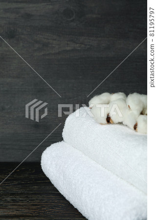 Clean folded towels with cotton on wooden background, close up 81195797