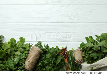 Fresh herbs on white wooden background, space for text 81195840