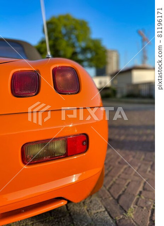 orange sports car convirtable parked in amsterdam 81196171