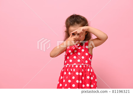 Pretty girl looking through the finger frame, posing to camera over pink background with copy space. International Girls Day concept. Facial emotions, positivity, happy childhood. Pretty girl looking through the finger frame, posing to camera over pink background with copy space. International Girls Day concept. Facial emotions, positivity, happy childhood. 81196321